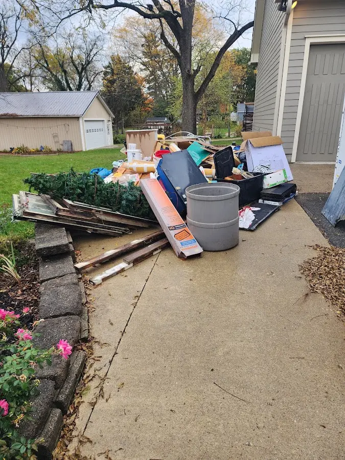 Dumpster being loaded with debris for Estate Cleanout Dumpster Rental in Perinton
